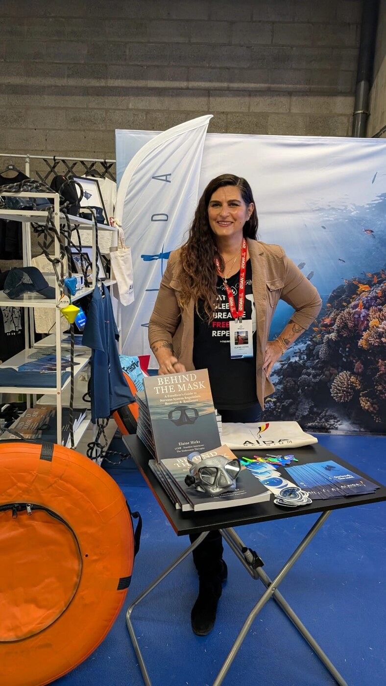 Elaine Hicks presenting her book Behind the Mask at a freediving event